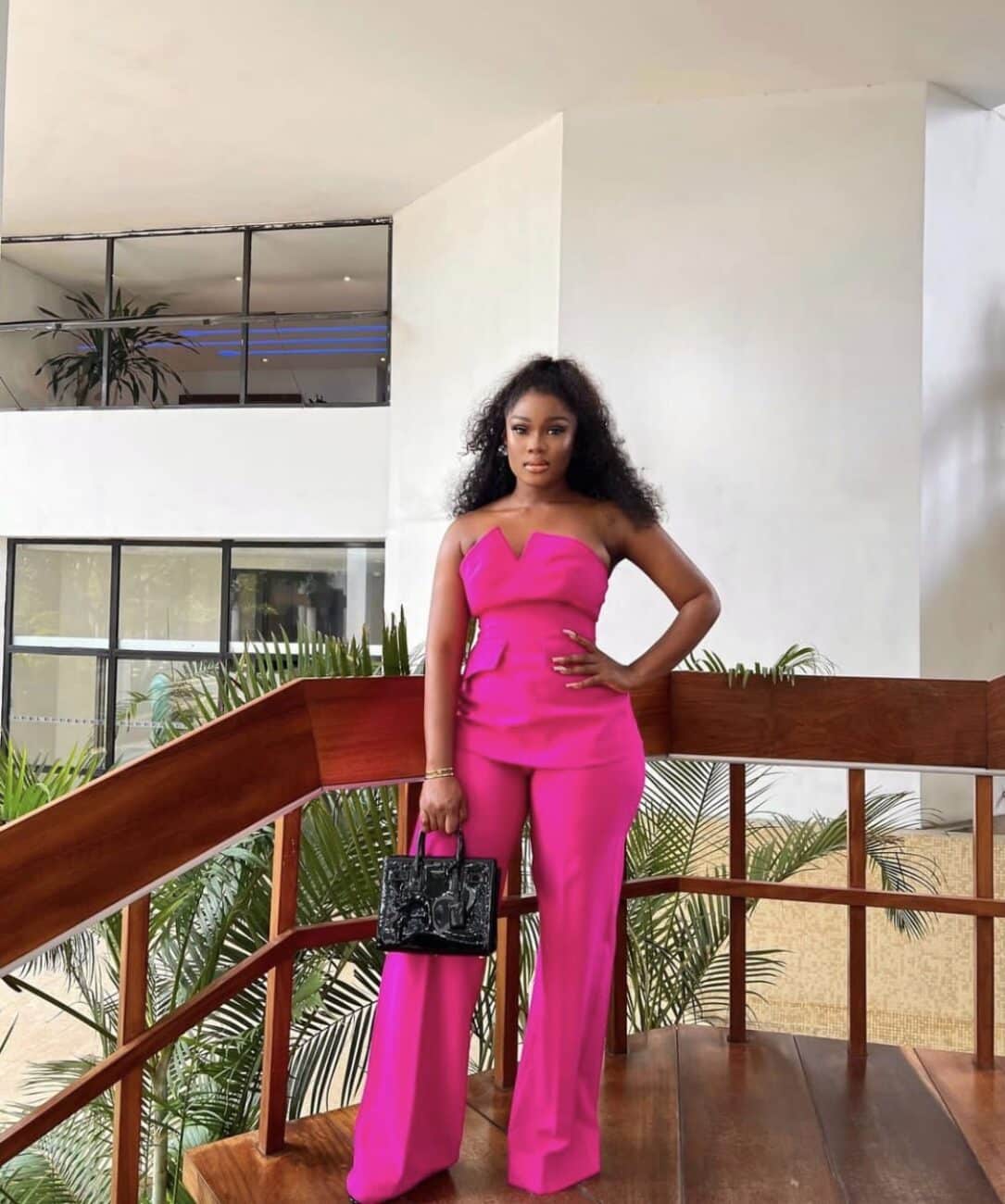 Ceec in a pink two piece outfit.