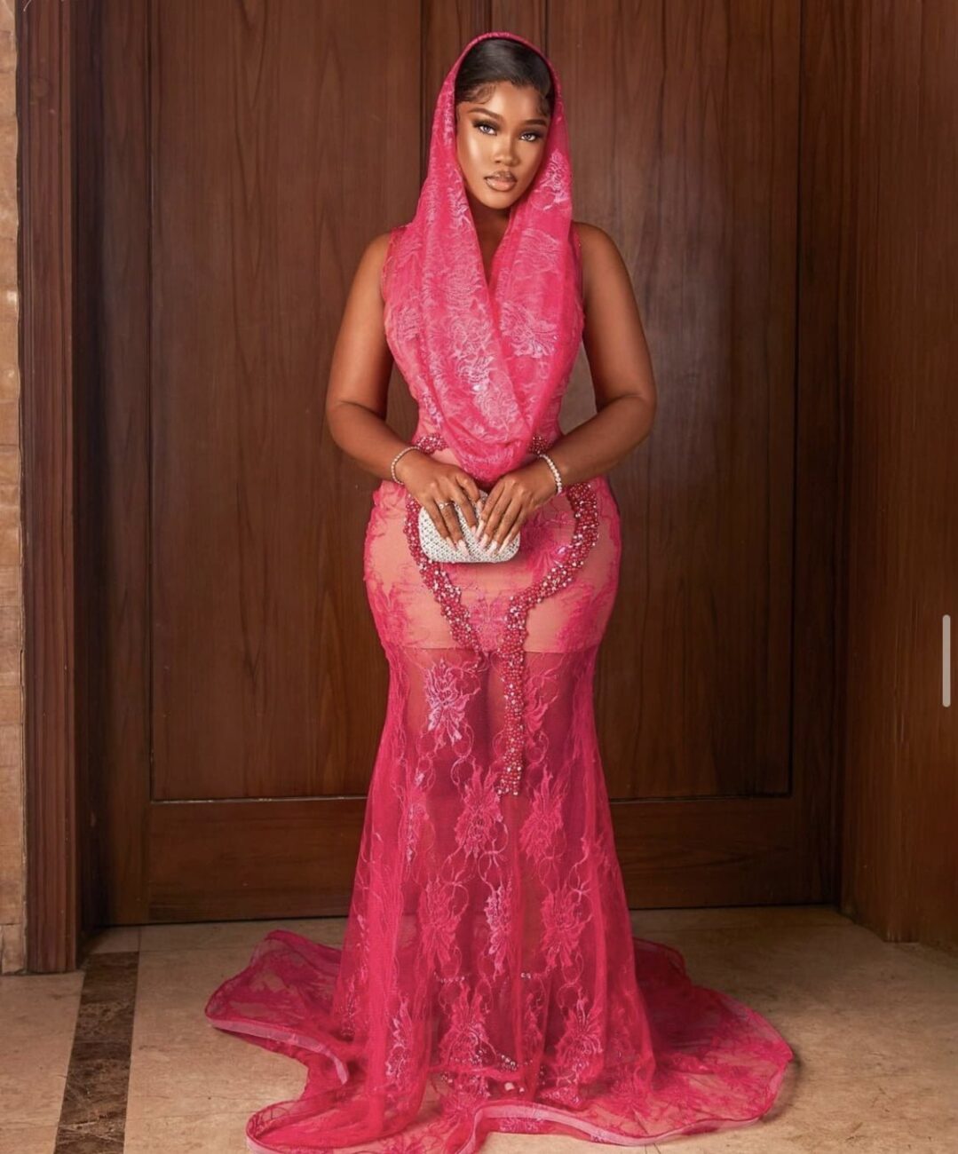 Ceec in a lace dress with a hoodie.